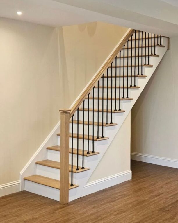 Oak staircase with black metal spindles, white painted risers and oak treads by Overgreen Joinery