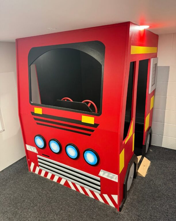 Bespoke wooden fire engine playhouse with red finish and realistic details for children