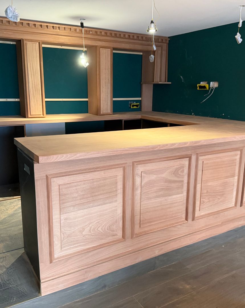 Bespoke oak kitchen island with traditional raised panel doors and solid wood worktop