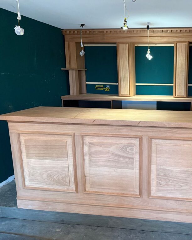 Traditional oak kitchen units with raised panel doors and crown molding details