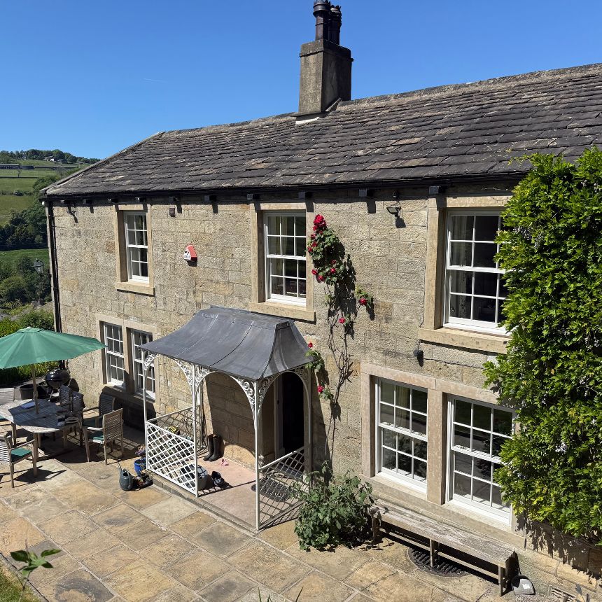 Traditional sash windows with glazing bars in period stone cottage set in Yorkshire countryside